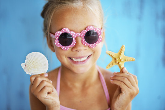 Child holding seashell