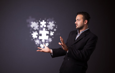 Puzzle pieces in the hand of a businessman