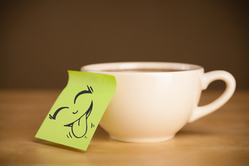 Post-it note with smiley face sticked on cup