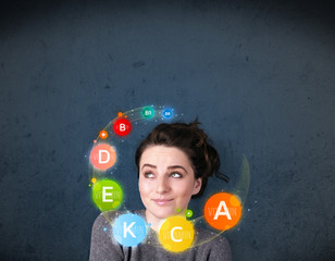 Young woman thinking with vitamins circulation around her head