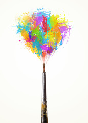 Obraz premium Brush close-up with colored paint splashes