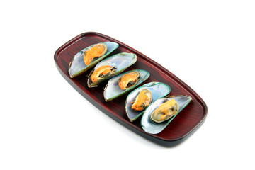 Mussels on wooden dish.