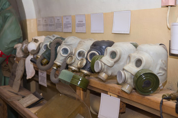 old gas masks in military soviet bunker