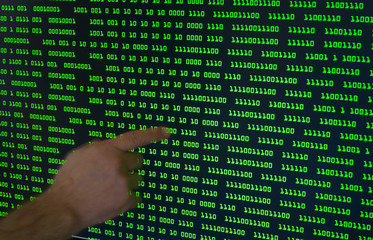 binary code with a pointing finger, surveillance concept