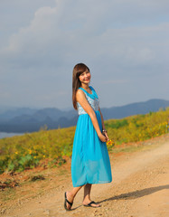 beautiful young girl in a meadow in summer