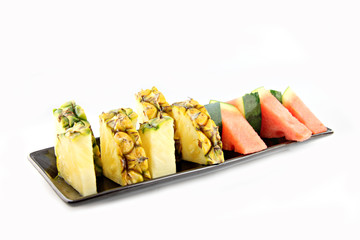 Pineapple and Watermelon slice Arranged in the black dish.