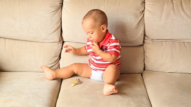 Little Child Playing on the Sofa