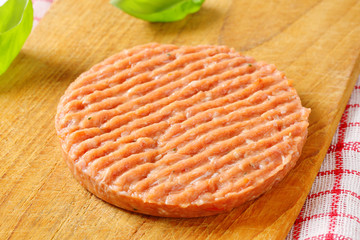 Raw burger patty