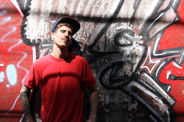 Fototapeta na wymiar Rapper leaning on a Wall.