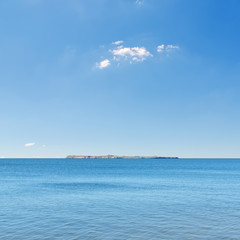 blue sea and sky, island on horizon