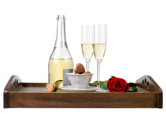 Obraz na płótnie Canvas Rose, champagne and chocolates on a wooden tray