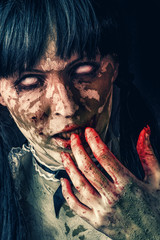 Scary zombie woman with bloody eyes