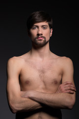Fototapeta premium Shirtless man. Young shirtless men standing isolated on grey and