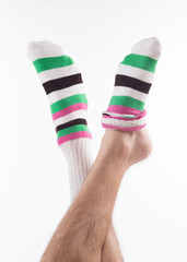 Funky socks. Legs in funky socks isolated on white