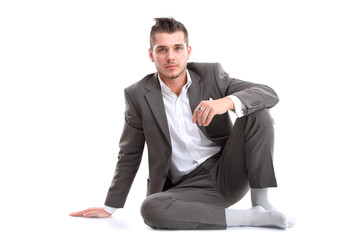 Portrait of business man sitting on the floor isolated