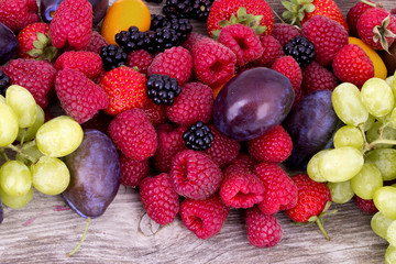 tasty summer fruits on a wooden table