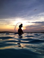man in water at dusk