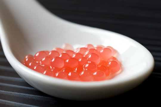 Fototapeta Molecular melon caviar balls on spoon