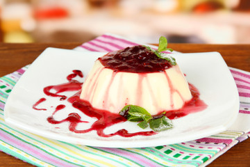 Panna Cotta with raspberry sauce, on bright background