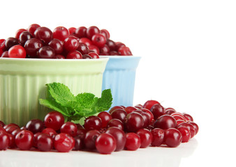 Ripe red cranberries in bowls, isolated on white.