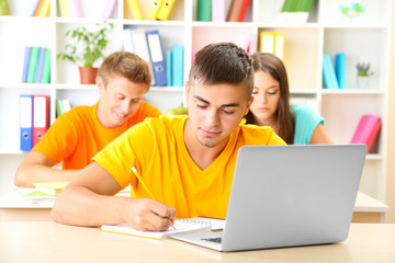 Group of young students sitting at the library