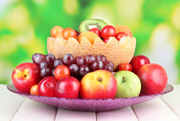 Fototapeta na wymiar Assortment of juicy fruits on wooden table, on bright