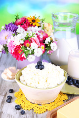 Fresh cottage cheese with blueberry on wooden table close-up