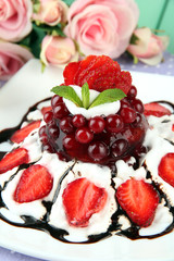 Tasty jelly dessert with fresh berries, on pink roses