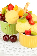 Delicious  ice cream with fruits and berries in bowl close up