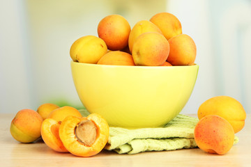 Fresh natural apricot in bowl on table in kitchen