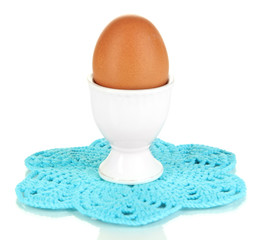 Whole boiled egg in egg cup isolated on white