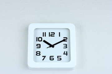 Office clock on color wall background