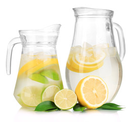 Cold water with lime, lemon and ice in pitchers isolated