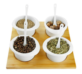 Assortment of spices in  white  bowls,