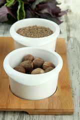 Assortment of spices in  white  bowls, on wooden background