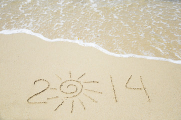 Number 2014 on the sand - holiday concept