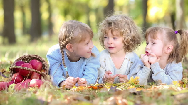Group of happy children playing outdoors in autumn park