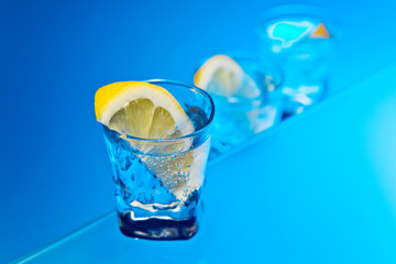 gin with lemon on a glass table