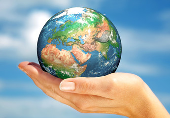 Hand of the person holds globe.