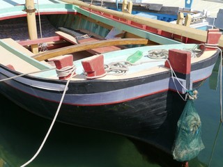 Fototapeta na wymiar Ancient wooden fishing boat in the small harbour of Betina