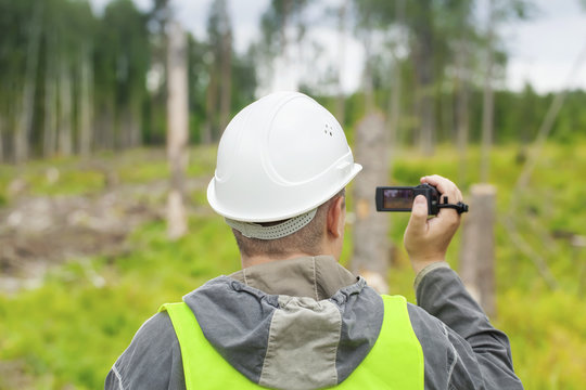 Forest Officer with a video camera filmed deforest