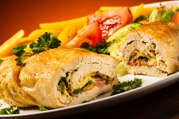 Fried wrapped meat, French fries and vegetables