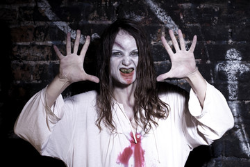 Bloody and scary looking zombie woman