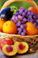 Naklejka na ściany i meble Basket full of citrus fruits and peaches