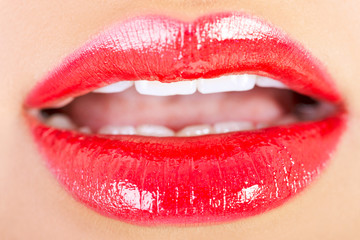  Closeup shoot of beautiful lips of woman with red lipstick