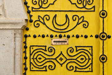 Beautifull traditional yello door of Tunisia with black ornament