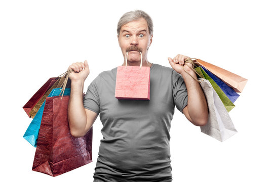 surprised mature man holding shopping bags isolated on white bac