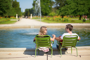 Couple relaxing in the Tuileries garden of Paris