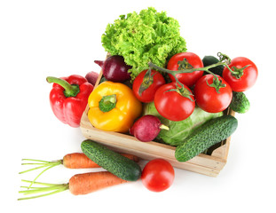 Fresh vegetables in wooden box on grey background