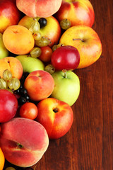 Assortment of juicy fruits, on wooden background